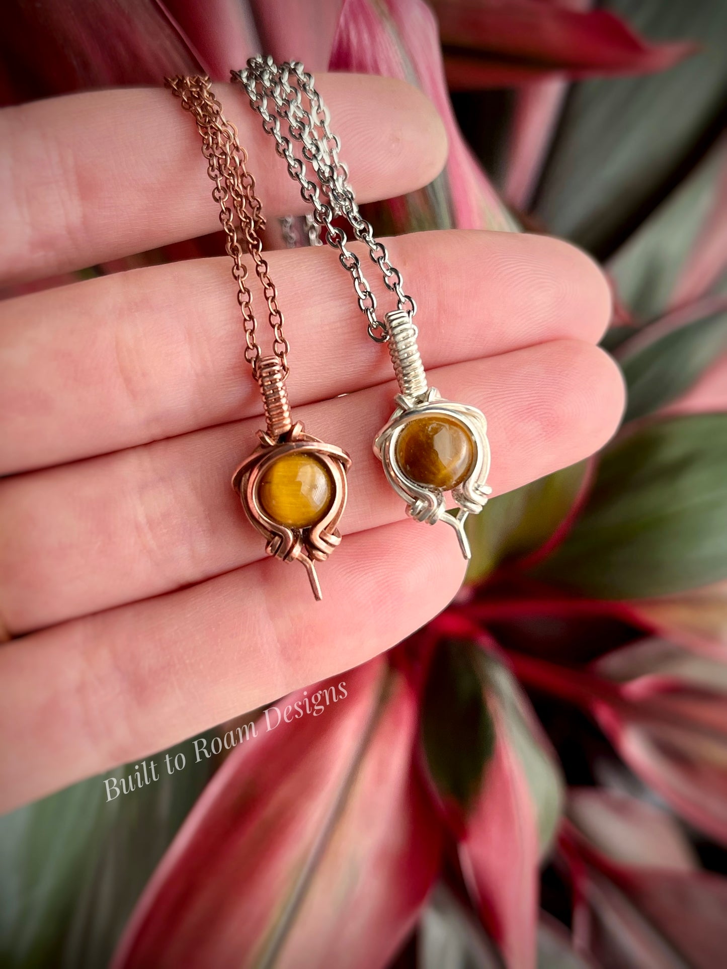 Hand holding Tiger’s Eye pendant necklace from Tiny But Mighty collection, silver and copper, front view