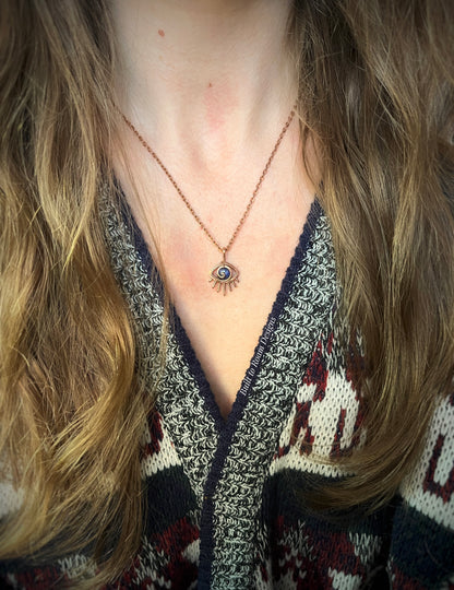 Person wearing a Copper eye-shaped pendant necklace with a blue Sodalite gemstone - front view - Insight