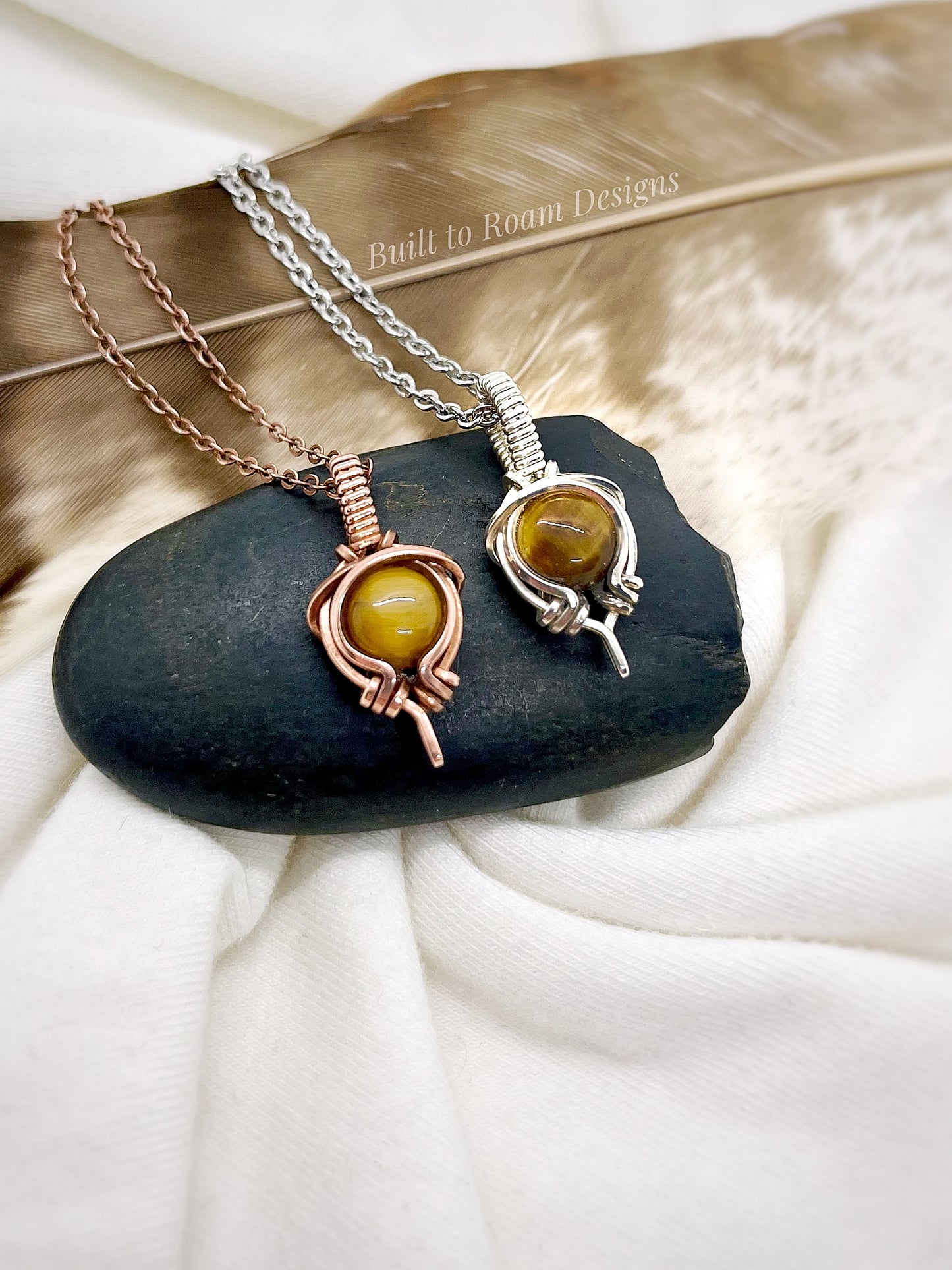Tiger’s Eye pendant necklace from Tiny But Mighty collection, silver and copper, front view on dark stone