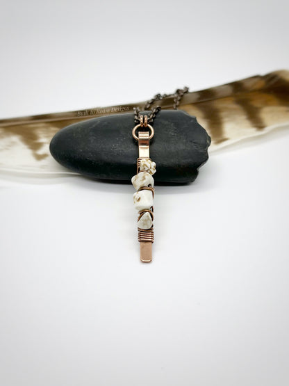 Copper bar necklace with white turquoise chip beads on a rock - side view - Horizon 