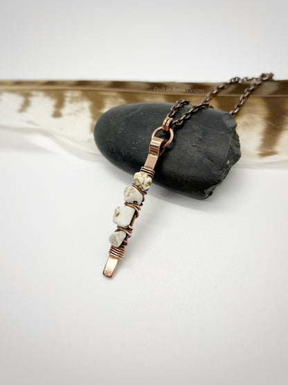 Copper bar necklace with white turquoise chip beads on a rock - side view - Horizon 