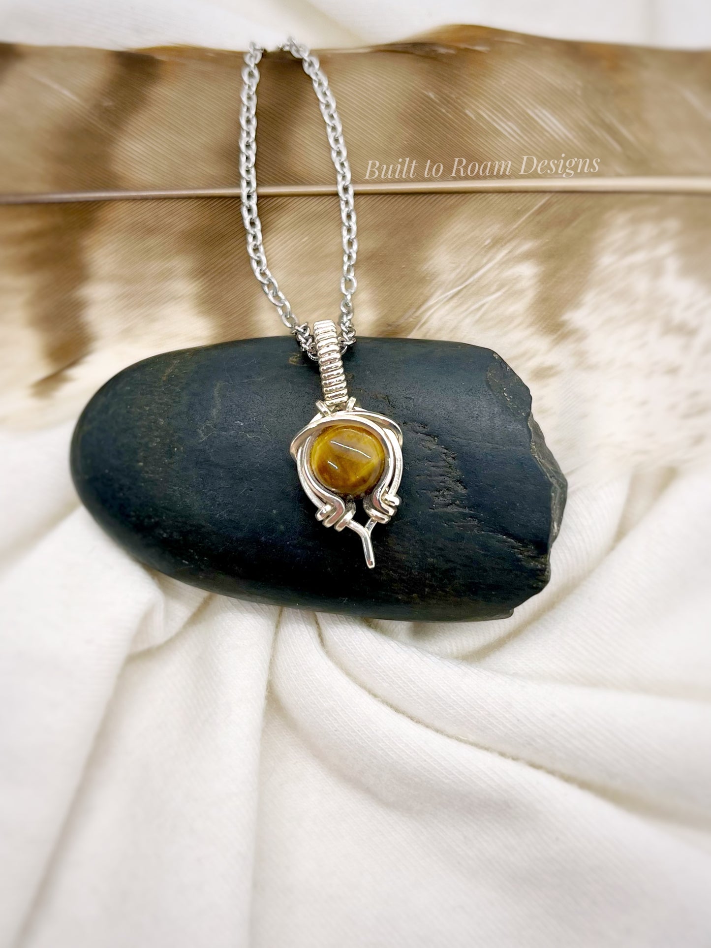Tiger’s Eye pendant necklace from Tiny But Mighty collection in silver, front view on dark stone