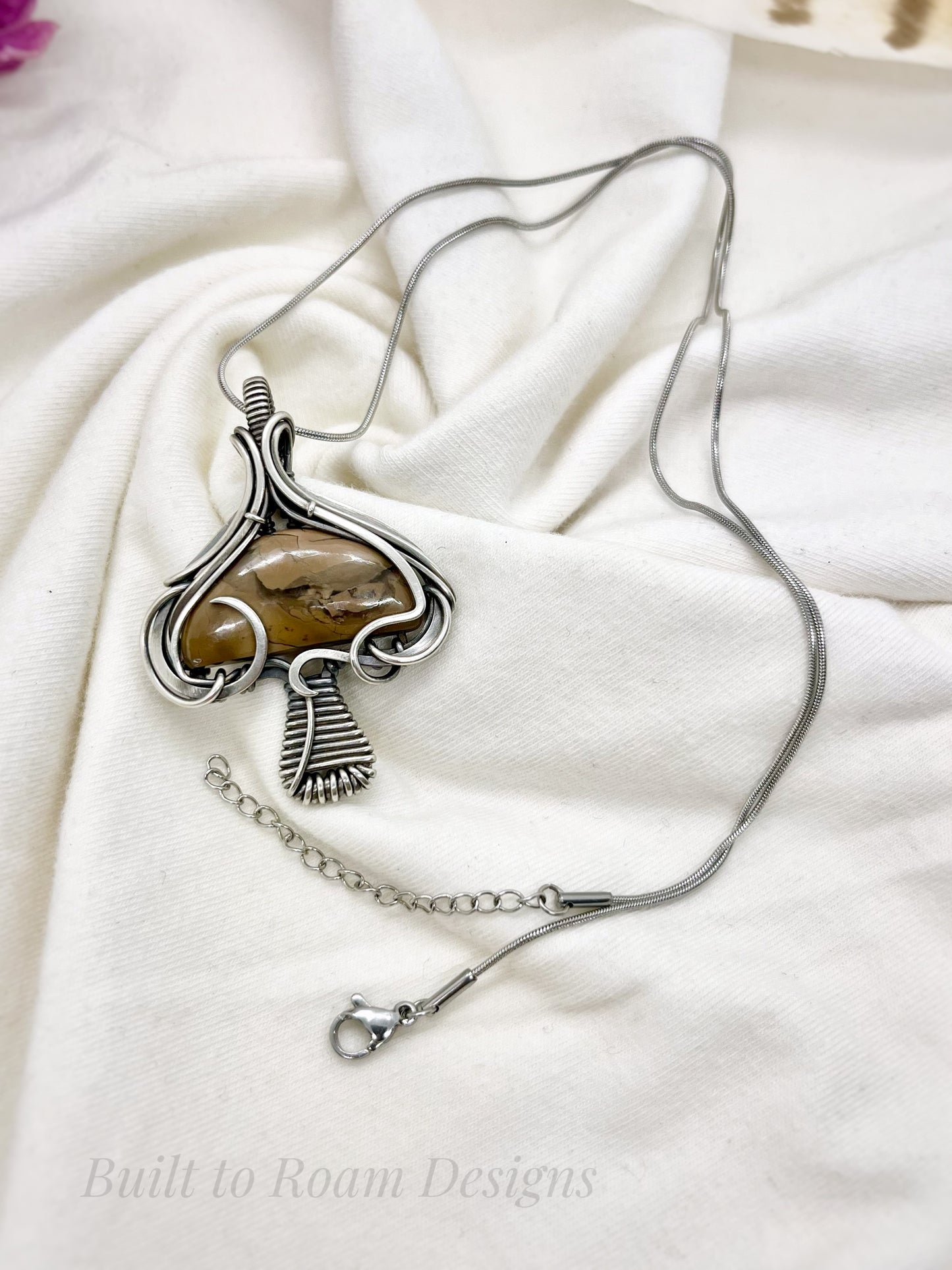 Silver mushroom-shaped pendant with a brown Mookaite Jasper gemstone on a necklace - side view