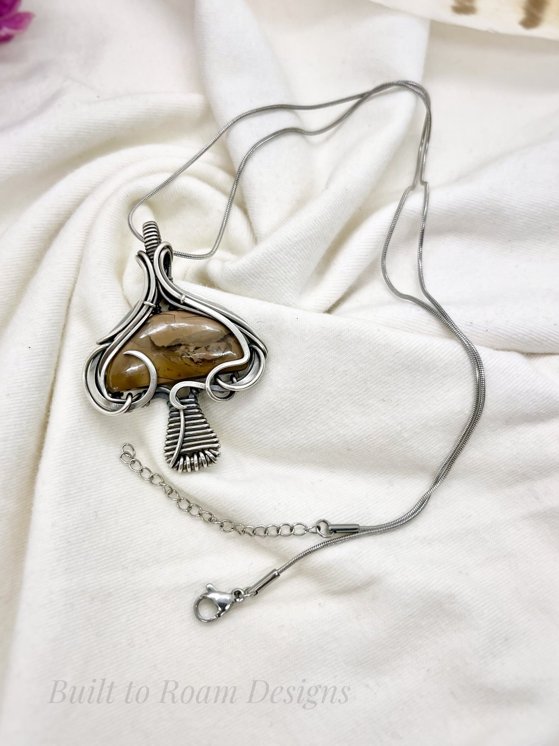 Silver mushroom-shaped pendant with a brown Mookaite Jasper gemstone on a necklace - side view