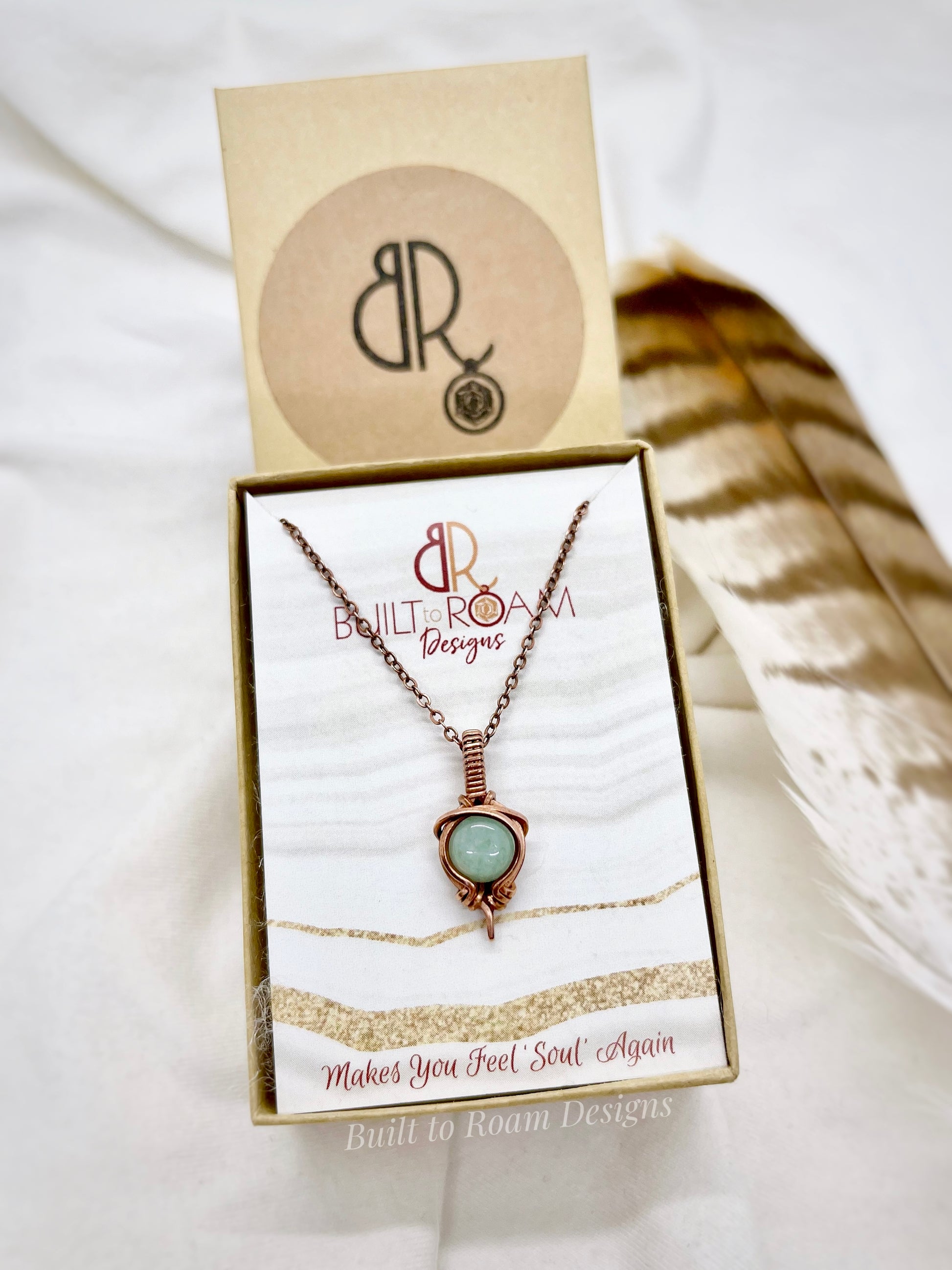 Copper Necklace with green aventurine gemstone pendant in a 'Built to Roam Designs' box on a white background