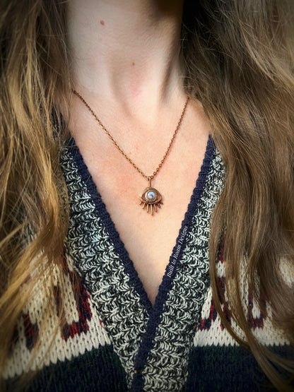 Person wearing a Copper eye-shaped pendant necklace with a blue lace agate gemstone - side view - Comfort