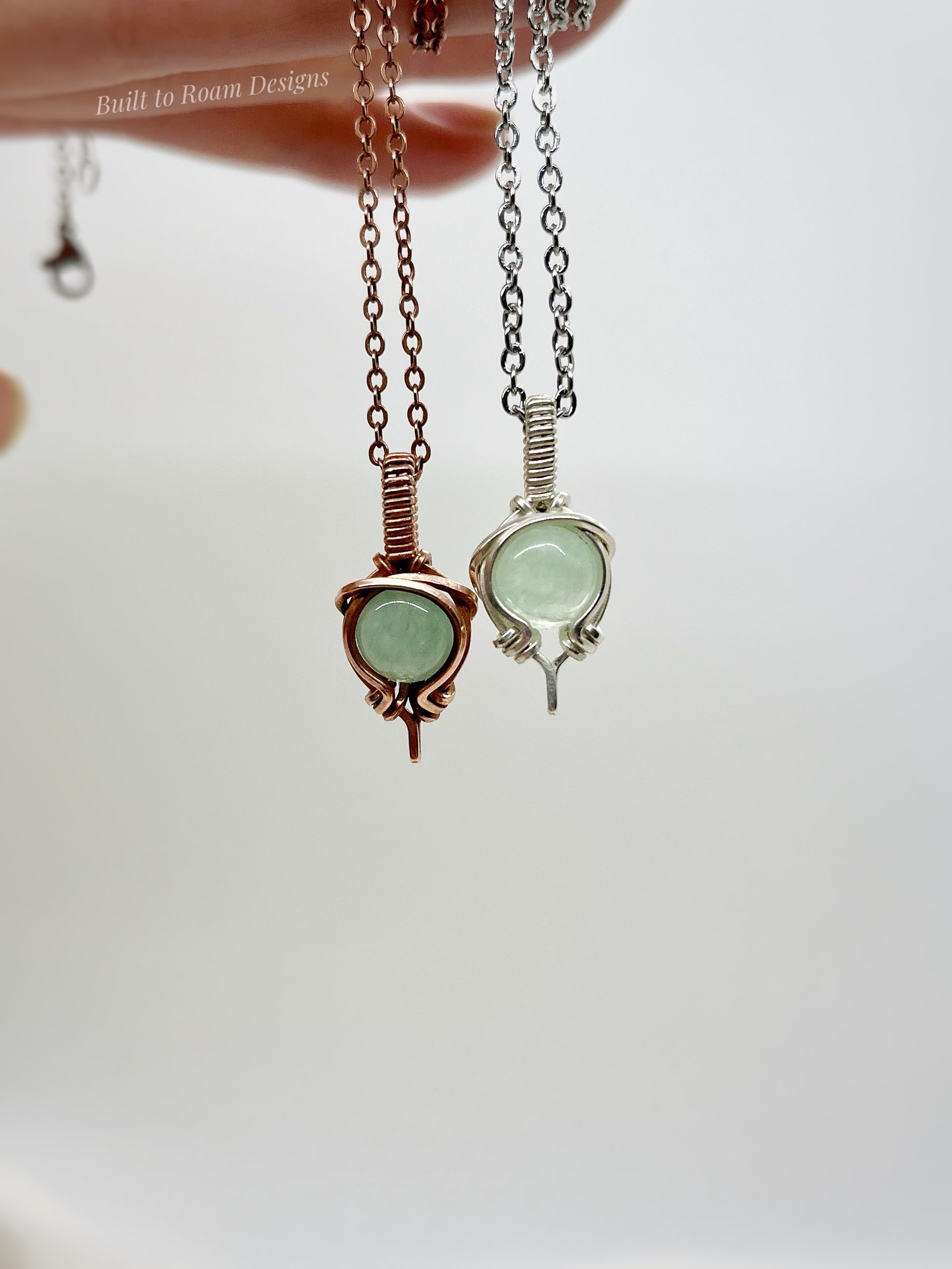 Two green aventurine gemstone necklaces in copper and silver on a white background.