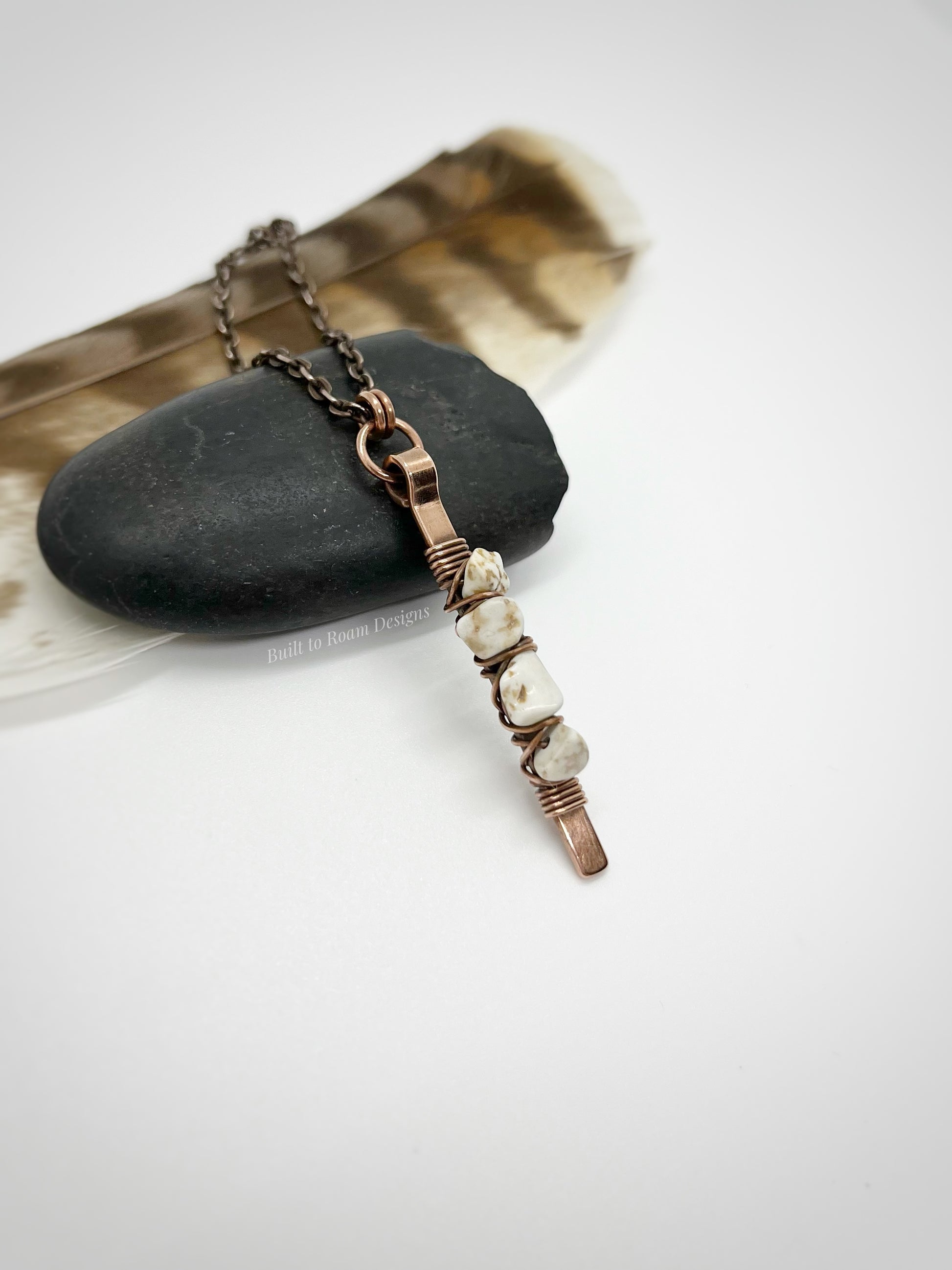 Copper bar necklace with white turquoise chip beads on a rock - side view - Horizon 