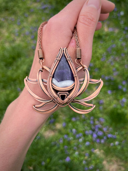 Copper lotus flower Viking knit chain necklace with purple amethyst gemstone held by a hand - front view - Elysian