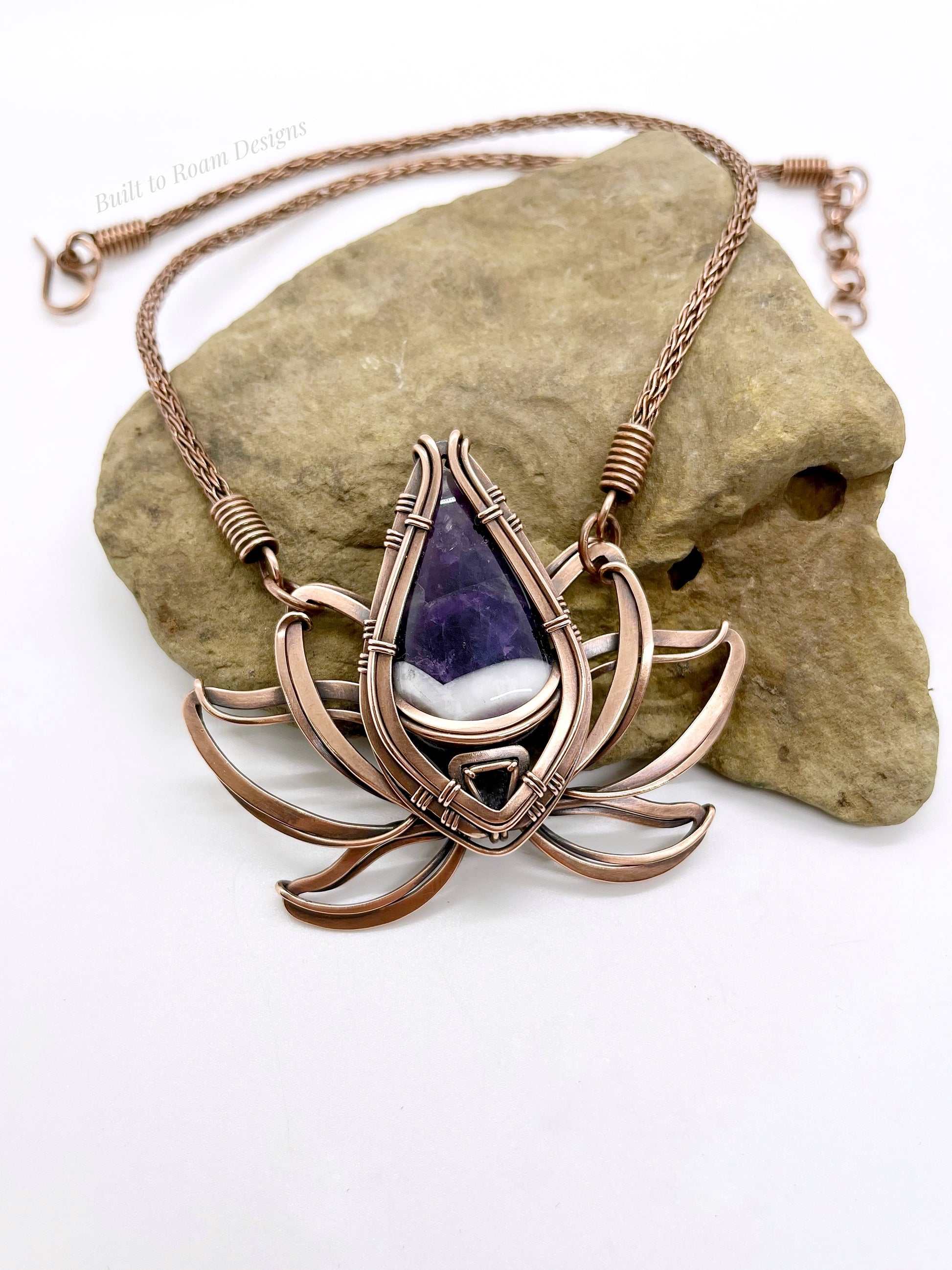 Copper lotus flower Viking knit chain necklace with purple amethyst gemstone on a rock - Elysian