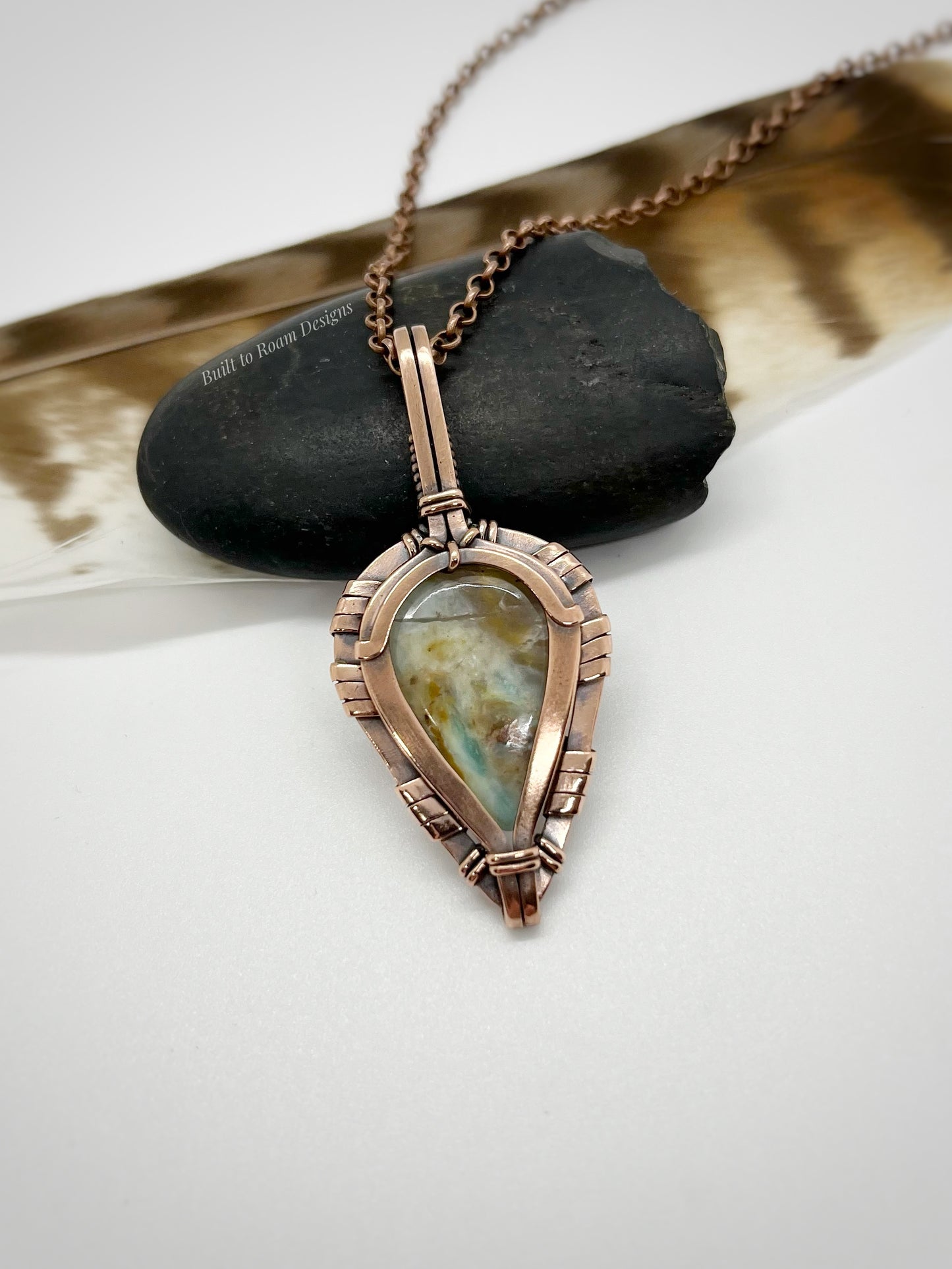 Necklace with a peruvian opal in copper pendant on a white background