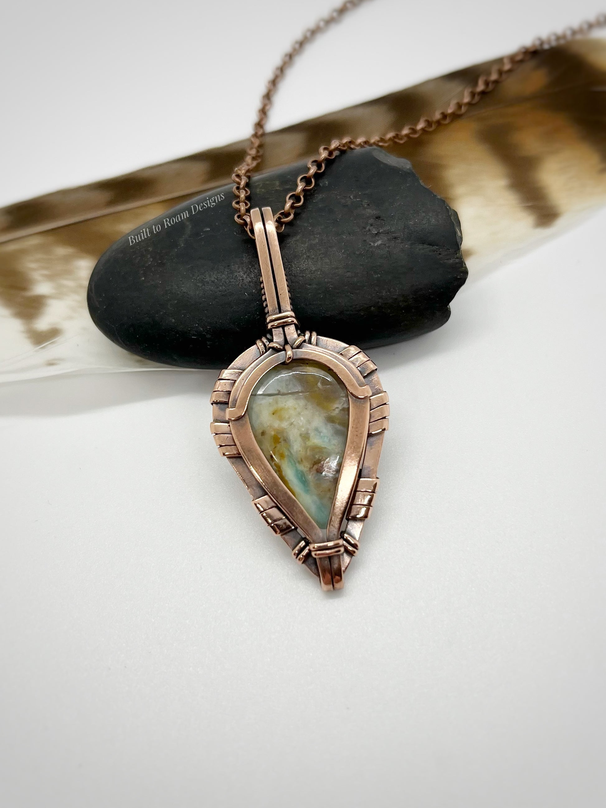 Necklace with a peruvian opal in copper pendant on a white background